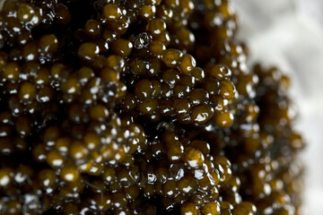 Black caviar. Close-up. Macro photography of delicacy. Background.