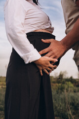 pregnant woman holding her belly