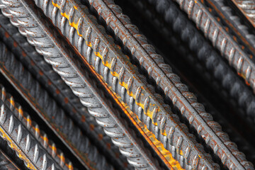 Detailed macro photo of steel reinforcement bars featuring orange rust