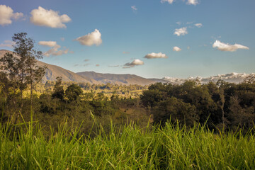 The majestic Iguaque mountain illuminated by the light of the sunset, with the forests and farms in its hillside and on the valley bellow.