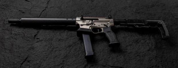 Tactical semi automatic rifle on black stone surface