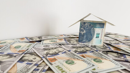 House Made of Polish Zloty Banknote on US Dollar Bills – Finance and Investment Concept
