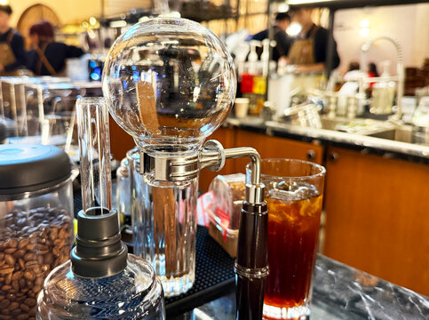 Stainless steel clamp with round bottom flask background.