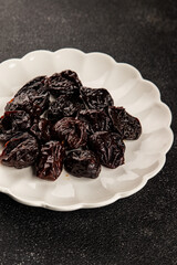 Prunes smoked plum portion size natural product tasty snack fresh delicious gourmet food background on the table rustic top view copy space keto and paleo diet vegetarian and vegan food