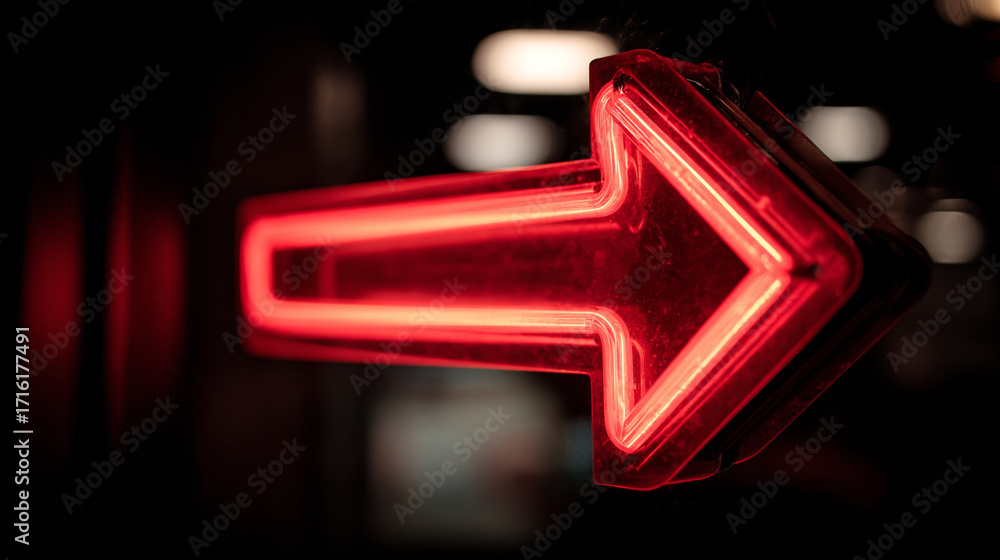 Poster a close up of a glowing red arrow sign pointing to the right in the dark