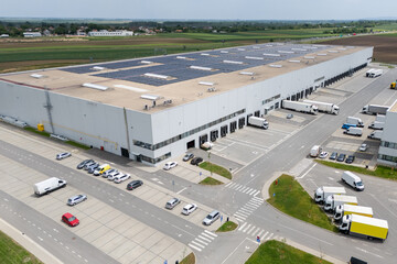 Logistics centers with solar panels on roofs. Aerial view