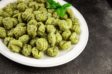 Gnocchi spinach potato dough second course portion size natural product tasty snack fresh delicious gourmet food background on the table rustic top view copy space