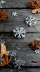 Minimalist vertical image of snowflake clusters and dry leaves on raw wooden planks, no text or logo