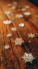 Delicate snowflake motifs with scattered leaves across polished wooden table, clear focus, no text or logo