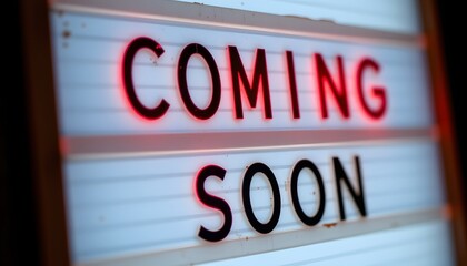 Coming Soon Illuminated Sign: A close-up of a backlit sign displaying the words COMING SOON, creating an anticipation for what's to come. The illuminated letters glow brightly.
