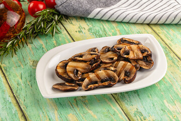 Tasty hot grilled champignon mushrooms