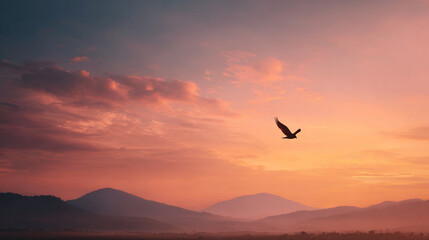 Naklejka premium Bird soaring over misty mountains at sunrise a peaceful scenic view