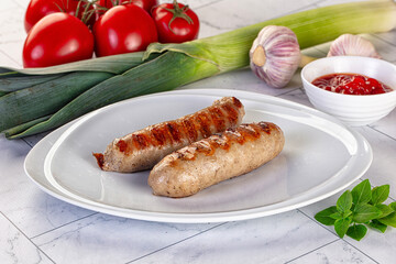 Grilled pork sausages served tomato sauce