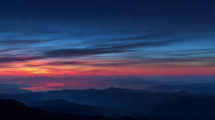 Fototapeta premium Scenic mountain range at twilight with a colorful sunset, creating a peaceful and serene landscape