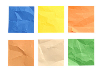 Six crumpled sticky notes in different  colours against white background