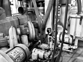 Industrial air blower system with electric motors in a factory. The blowers are used for ventilation, dust collection, or material transport in manufacturing processes. The image highlights the mechan