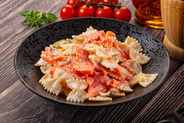 Italian pasta farfalle with salmon