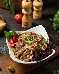 Delicious bowl of salad with tender beef and creamy dressing served in a cozy dining setting