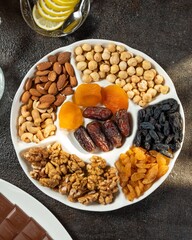 Healthy snack platter featuring assorted nuts and dried fruits, perfect for sharing or enjoying alone during gatherings