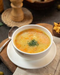 Delicious bowl of warm soup with veggies served in a cozy setting