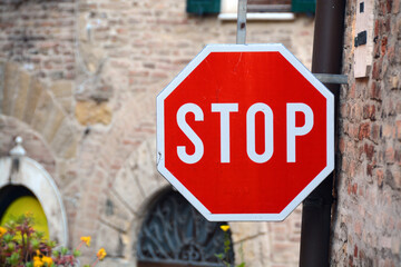 Stop Sign on Stone Wall in Tuscany, Italy