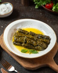 Delicious dolma filled with rice and herbs served on a wooden board