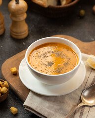 Delicious homemade tomato soup served on a wooden table with fresh herbs and croutons for a cozy meal experience