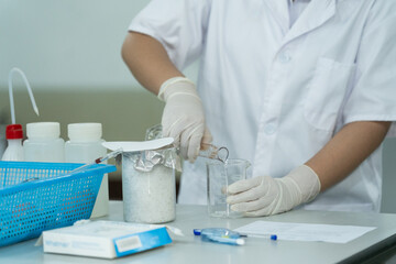 Medical Student Conducting Lab Experiment with Glassware