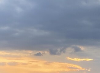 Obraz premium Twilight Sky with Layered Clouds and Warm Light Breaking Through