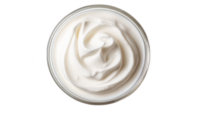 A close-up view of a creamy. textured whipped topping in a glass jar. its smooth surface and soft peaks. ideal for culinary presentations and dessert recipes