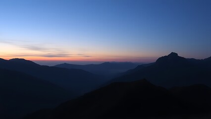 Fototapeta premium Mountain landscape bathed in twilight hues of deep blue and fading sunset colors.