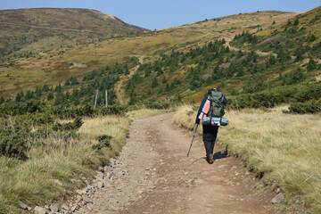 A man with a backpack is traveling in the mountains.