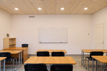 A Contemporary Classroom Featuring a Beautiful Wooden Ceiling and Stylish Desks for Learning