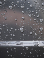 Black wet background / raindrops for overlaying on window, concept of autumn weather, background of drops of water rain on glass transparent