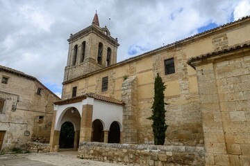 Bell tower and portico of Iglesia de la Asuncion in Autilla del Pino, Palencia, Spain