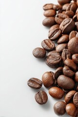 Roasted coffee beans scattered on a light background