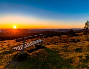Sunrise over a grassy hilltop with a bench