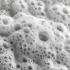 Extreme close-up of dense soap foam with tiny and large bubbles creating a textured surface pattern