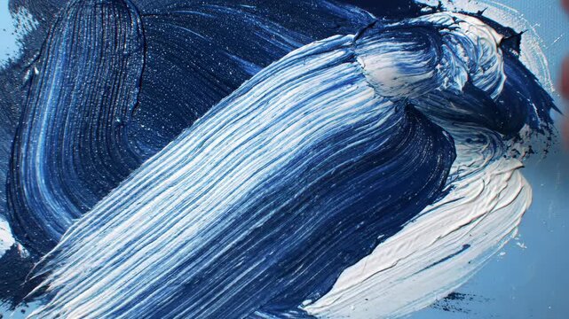 Blue and white acrylic paint strokes on canvas surface texture