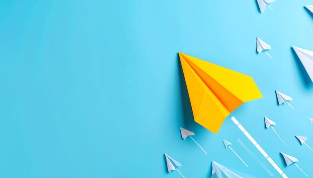 Bright yellow paper airplane leading a group of light blue paper airplanes