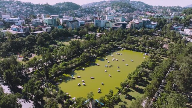 Aerial View of Burnham Park and Lake in Baguio, Philippines
the bustling Burnham Lake, where families, couples, and friends enjoy a variety of rental boats, including the iconic swan boats