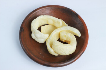 Kerupuk Kulit or cow skin crackes. Crackers made from processed genuine cowhide. They are cleaned, dried in the sun, and then fried. A typical Indonesian cracker. Isolated on a white background.
