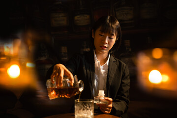  Closeup business woman holding a glass of whiskey