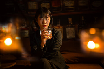 Businesswoman drinking alcohol holding a glass of whiskey 
