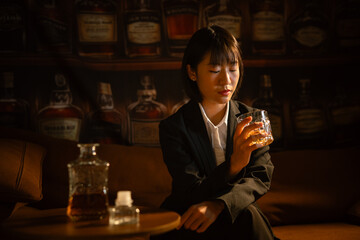 Closeup business woman holding a glass of whiskey