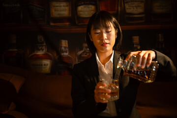 Closeup business woman holding a glass of whiskey