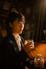 Closeup business woman holding a glass of whiskey