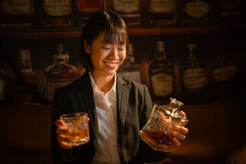 Closeup business woman holding a glass of whiskey