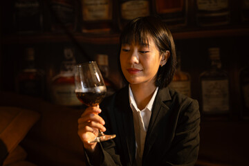  Closeup business woman holding a glass of wine