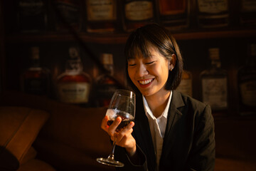  Closeup business woman holding a glass of wine
